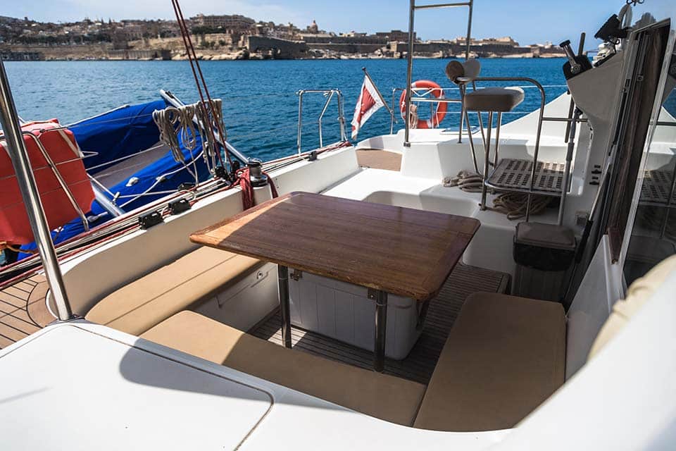 Outside lounge area of a catamaran for rent in Malta